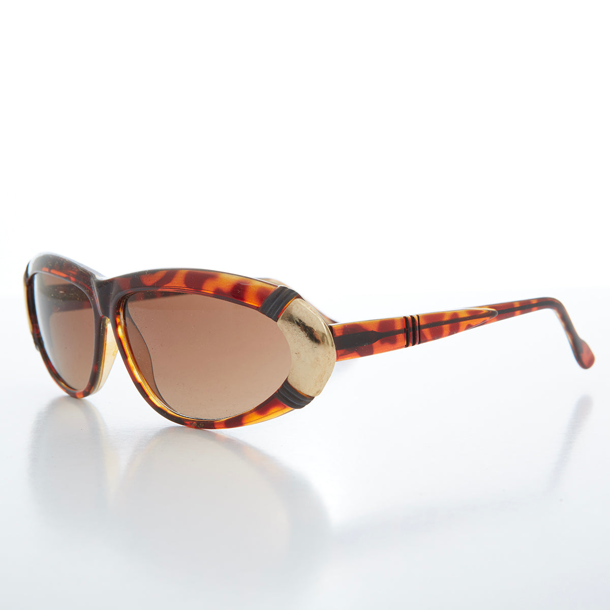 Women's 80s vintage sunglasses by Sunglass Museum, Rachel style with bold frame and tinted lenses on a white background.