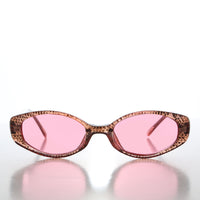 90s oval sunglasses with tinted lenses by Sunglass Museum, featuring a sleek frame and stylish vintage-inspired design.