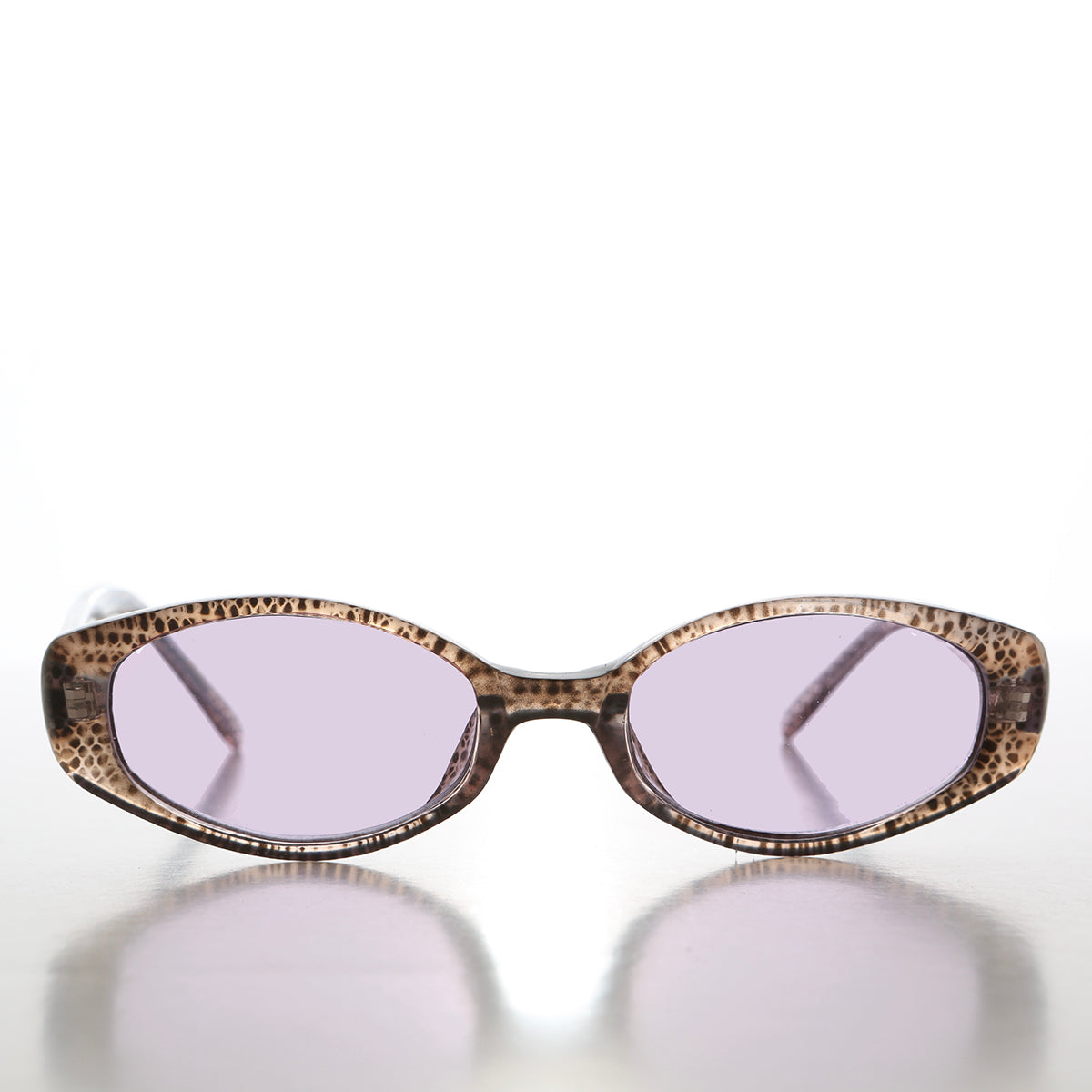 Helena 90s oval sunglasses with tinted lenses from Sunglass Museum, featuring a classic vintage design and dark tinted lenses.