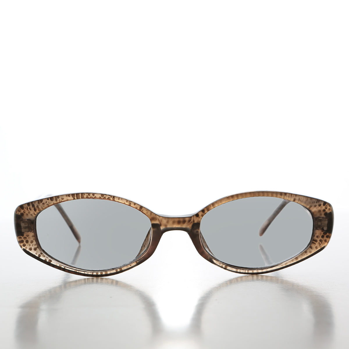 Vintage 90s oval sunglasses with tinted lenses from Sunglass Museum, featuring a classic retro style and slim frame design.