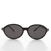 Large oval vintage women's sunglasses by Sunglass Museum with dark tinted lenses and stylish frame.