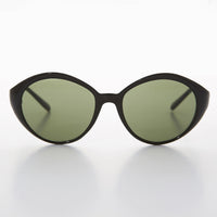 Round women's vintage sunglasses by Sunglass Museum with black frames and green-tinted lenses.
