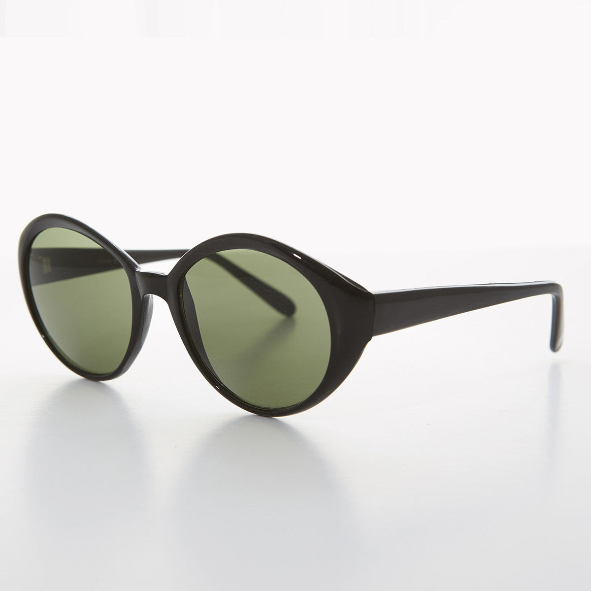 Round women's vintage sunglasses with black frames and green lenses by Sunglass Museum, stylish and retro eyewear.
