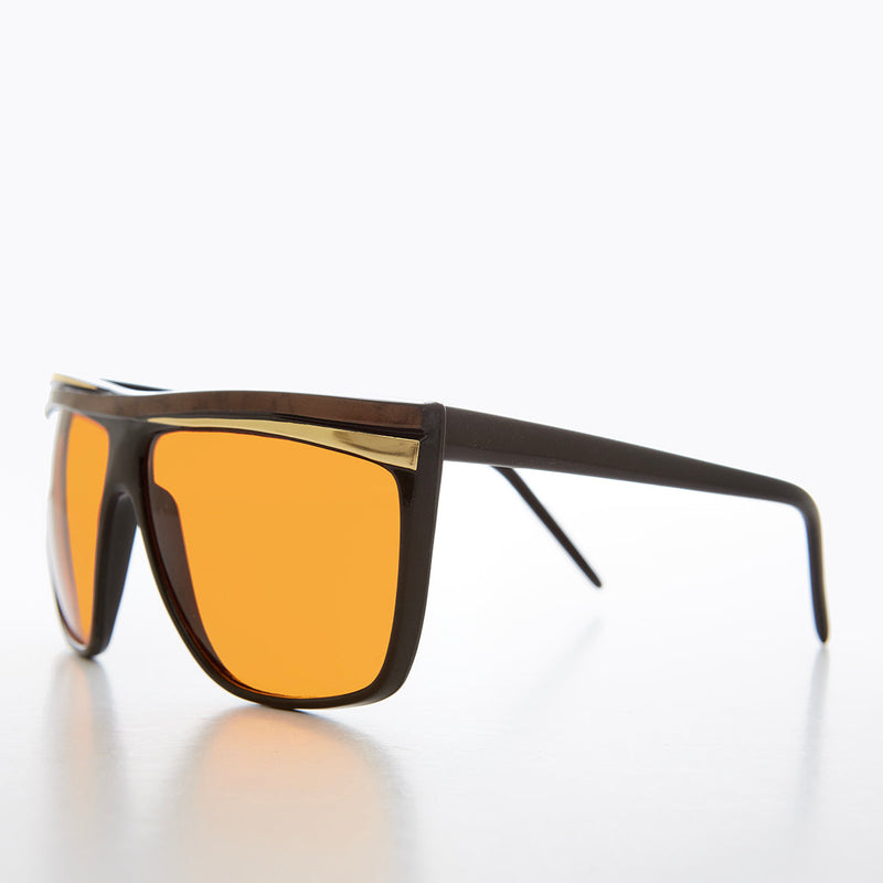 Women's 80s large sunglasses with orange lenses by Sunglass Museum, featuring bold frame and vibrant retro style.