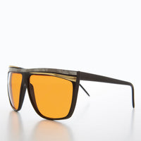 Women's 80s large sunglasses with orange lenses by Sunglass Museum, featuring bold retro style and oversized frame.