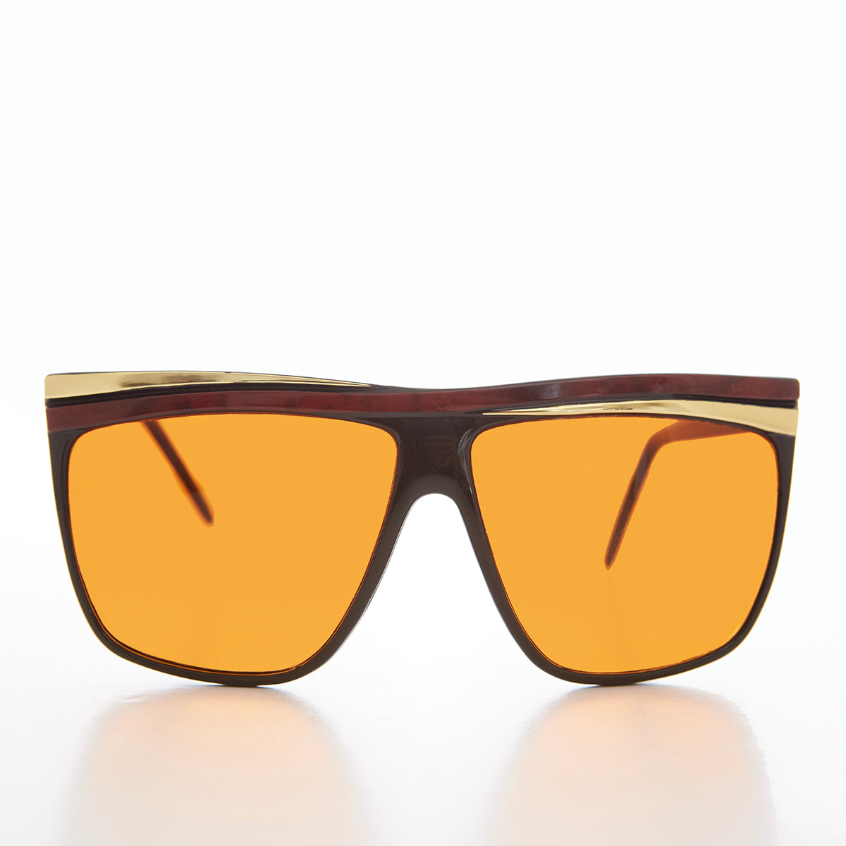 Women's 80s large sunglasses with orange lenses by Sunglass Museum, featuring bold frames and vintage style.