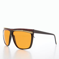 Women's 80s large sunglasses with orange lenses by Sunglass Museum, featuring bold vintage style and oversized frame.
