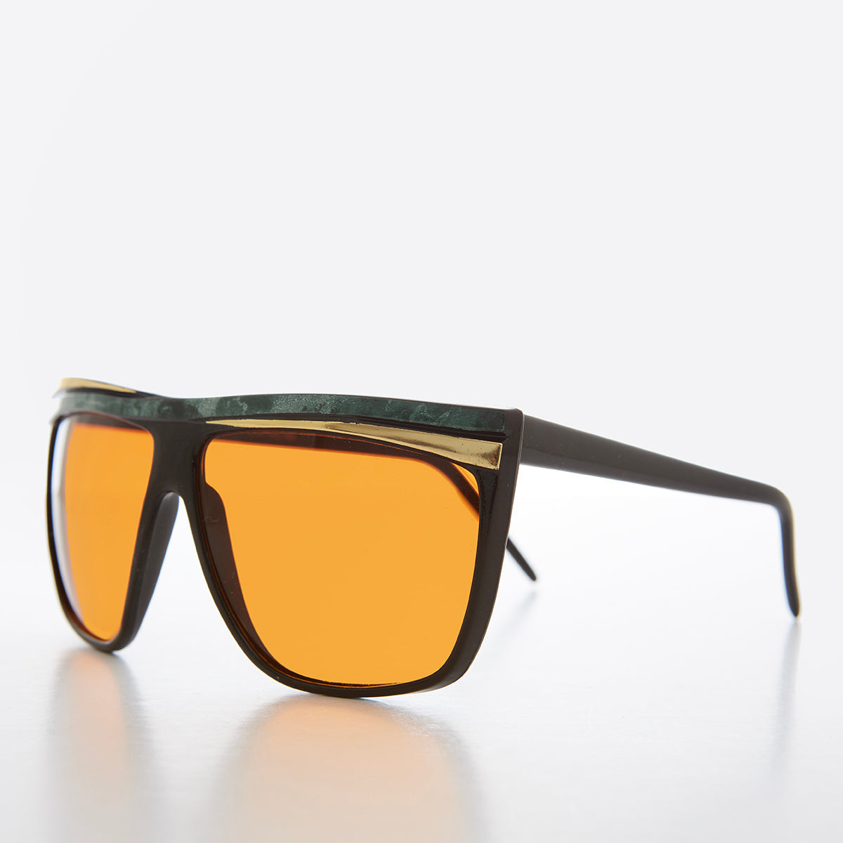 Women's 80s large sunglasses with orange lenses by Sunglass Museum, featuring bold retro design and oversized frame.