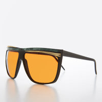 Women's 80s large sunglasses with orange lenses by Sunglass Museum, featuring bold retro design and oversized frame.