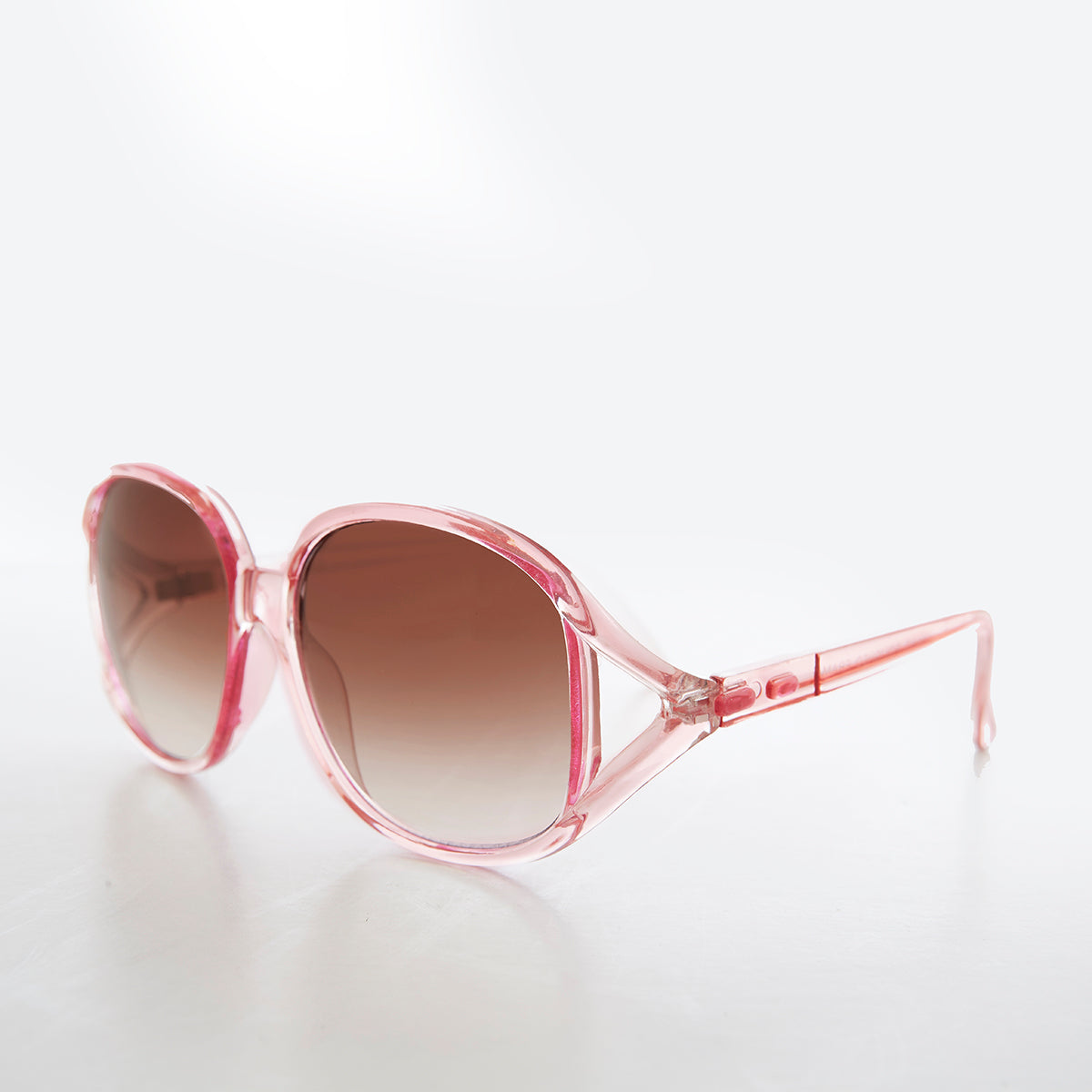 Large round oversized women's boho vintage sunglasses by Sunglass Museum, pink tinted lenses with bold frame design.