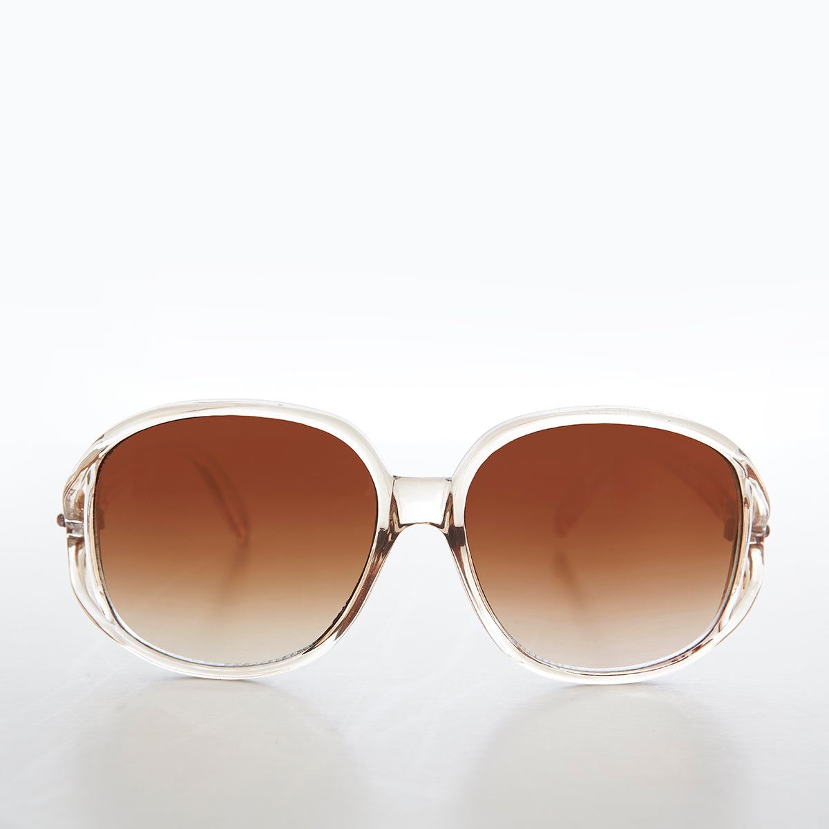 Large round oversized women's boho vintage sunglasses by Grace from Sunglass Museum with pink tinted lenses and stylish frame.