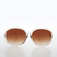 Large round oversized women's boho vintage sunglasses by Grace from Sunglass Museum with pink tinted lenses and stylish frame.
