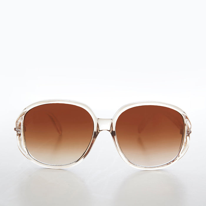 Large round oversized women's boho vintage sunglasses by Grace from Sunglass Museum with pink tinted lenses and stylish frame.