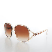 Large round oversized women's boho vintage sunglasses by Sunglass Museum featuring pink tinted lenses and retro style.