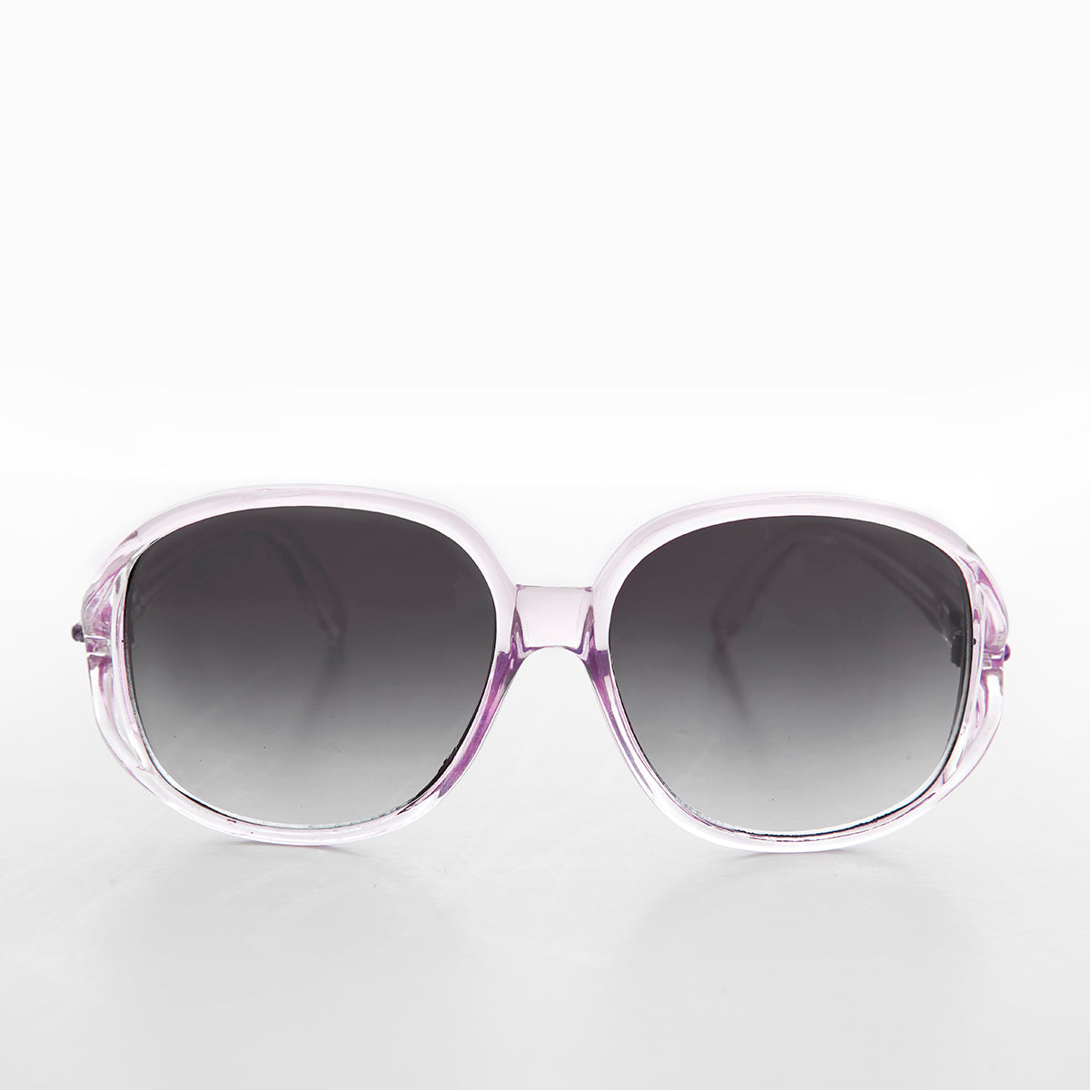 Large round oversized women's boho vintage sunglasses by Sunglass Museum with pink tinted lenses and retro design.