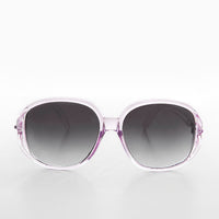 Large round oversized women's boho vintage sunglasses by Sunglass Museum with pink tinted lenses and retro design.