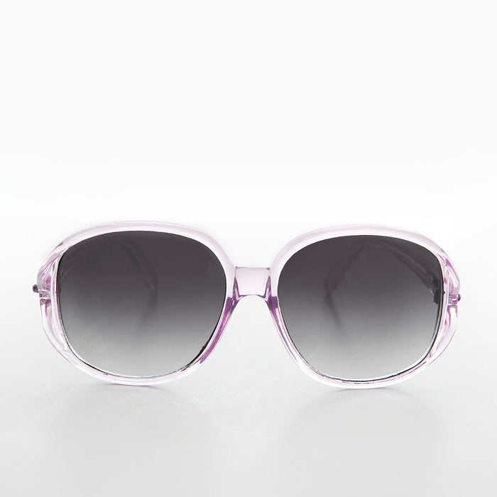 Large round oversized women's boho vintage sunglasses by Sunglass Museum with pink tinted lenses and retro design.