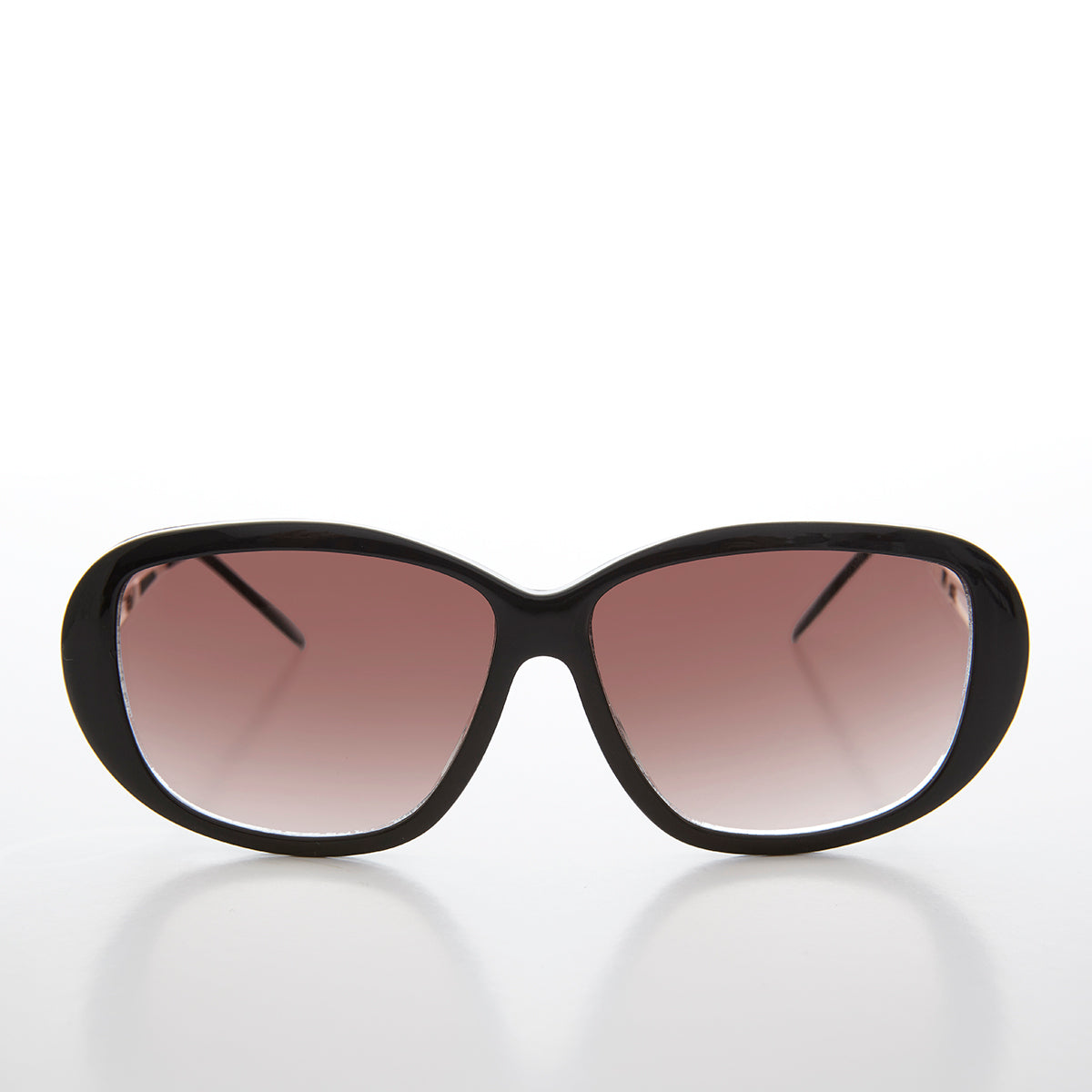 Large women's vintage deadstock sunglasses by Sunglass Museum with glamorous retro style, featuring bold frame and dark lenses.