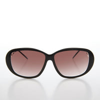 Large women's vintage deadstock sunglasses by Sunglass Museum with glamorous retro style, featuring bold frame and dark lenses.