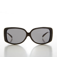 Women's 90s vintage drop temple sunglasses by Sunglass Museum with black frames and gray lenses.