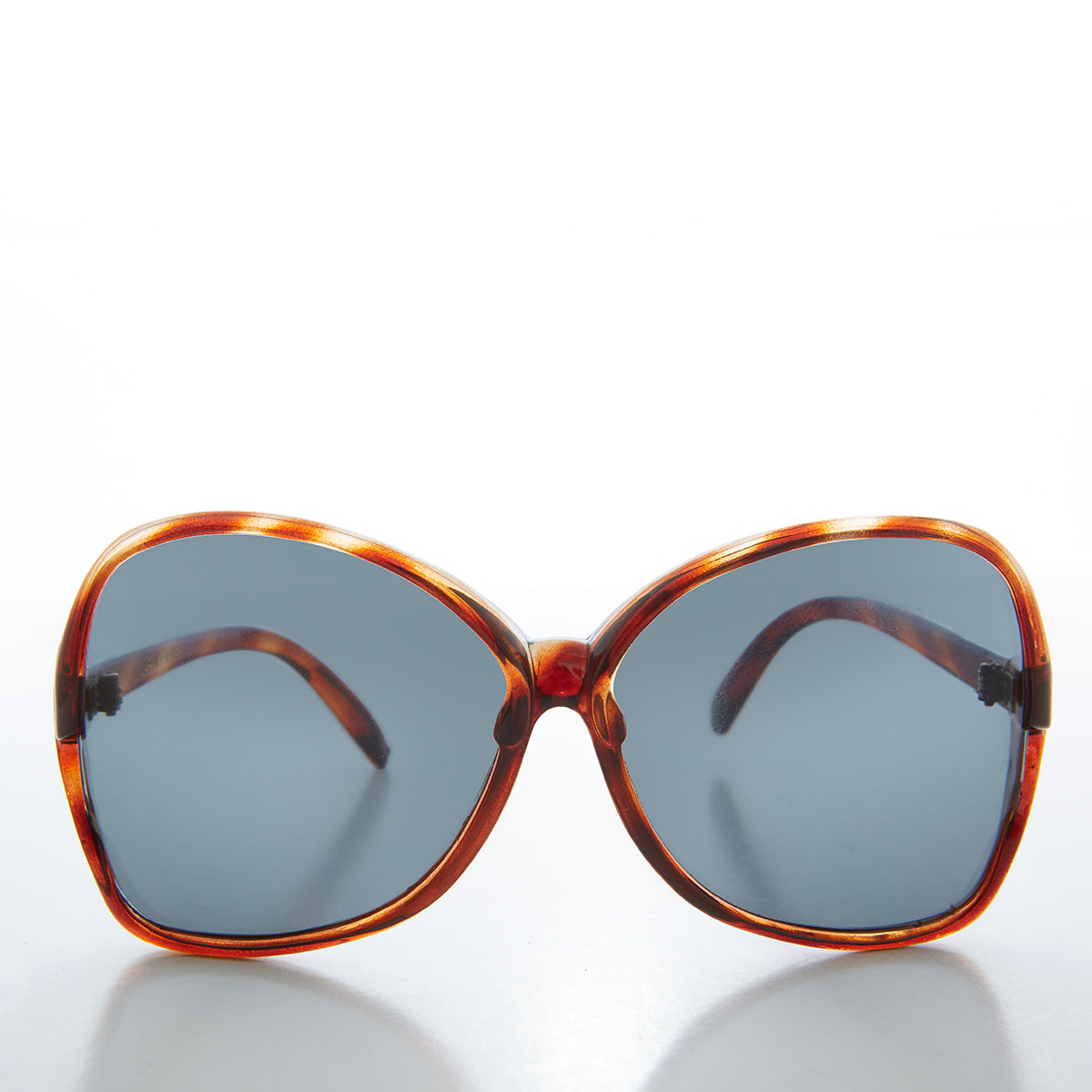 Large butterfly-style women's sunglasses from Sunglass Museum featuring bold frames and trendy 80s-inspired design.