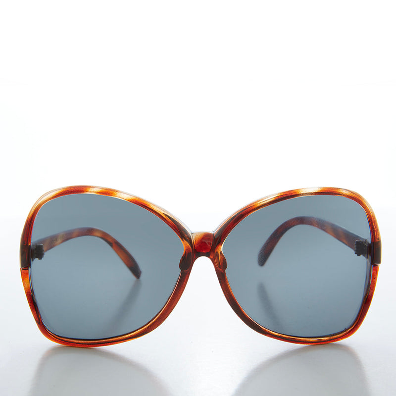 Large butterfly-style women's sunglasses from Sunglass Museum featuring bold frames and trendy 80s-inspired design.