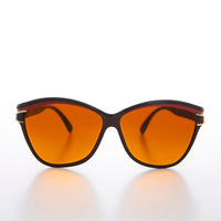 Black frame women's deadstock Margot sunglasses with chunky design and tinted lenses, from Sunglass Museum.