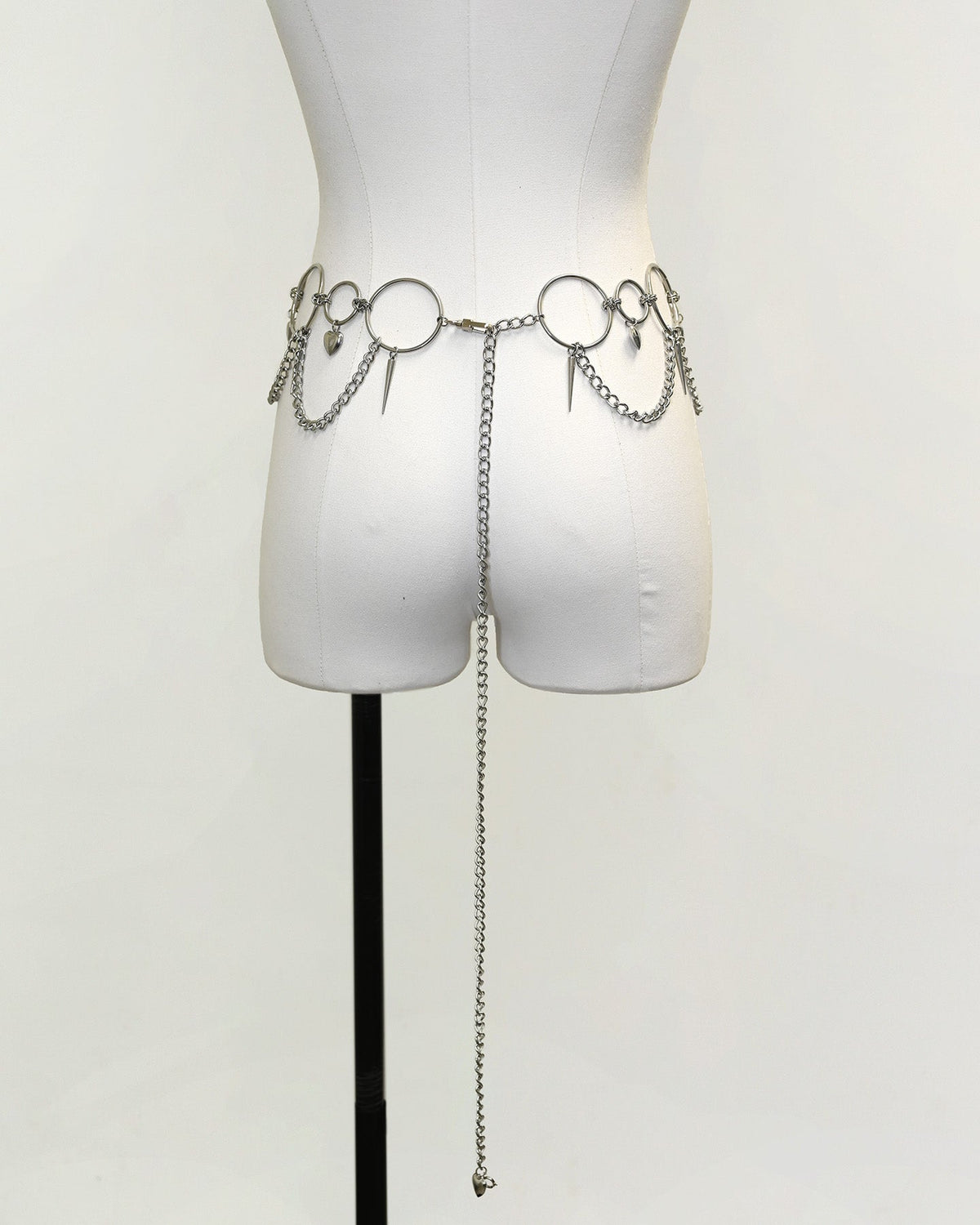 Silver Heartbreaker Waist Chain Belt by SUSPEX Rave Outfits, featuring a Y2K-style body chain accessory with heart details.