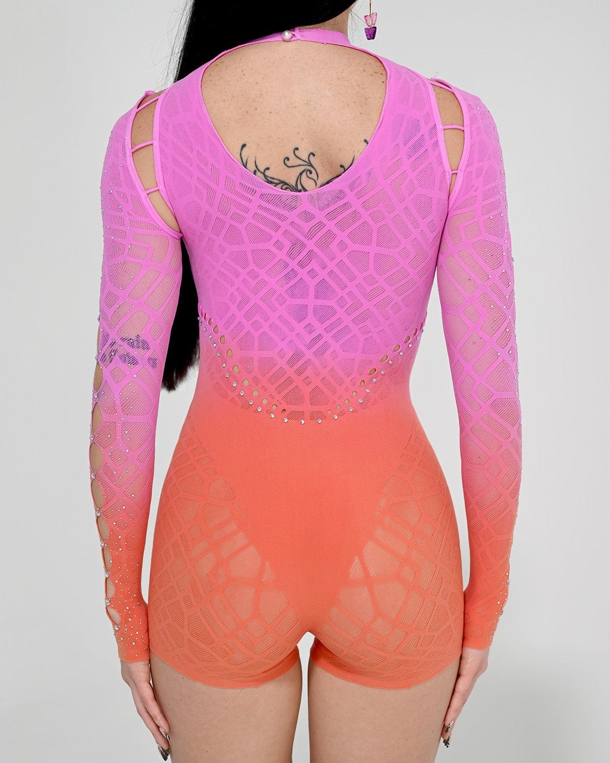 Sunset Rebel romper jumpsuit by SUSPEX Rave Outfits featuring a vibrant sunset design and stylish one-size fit.