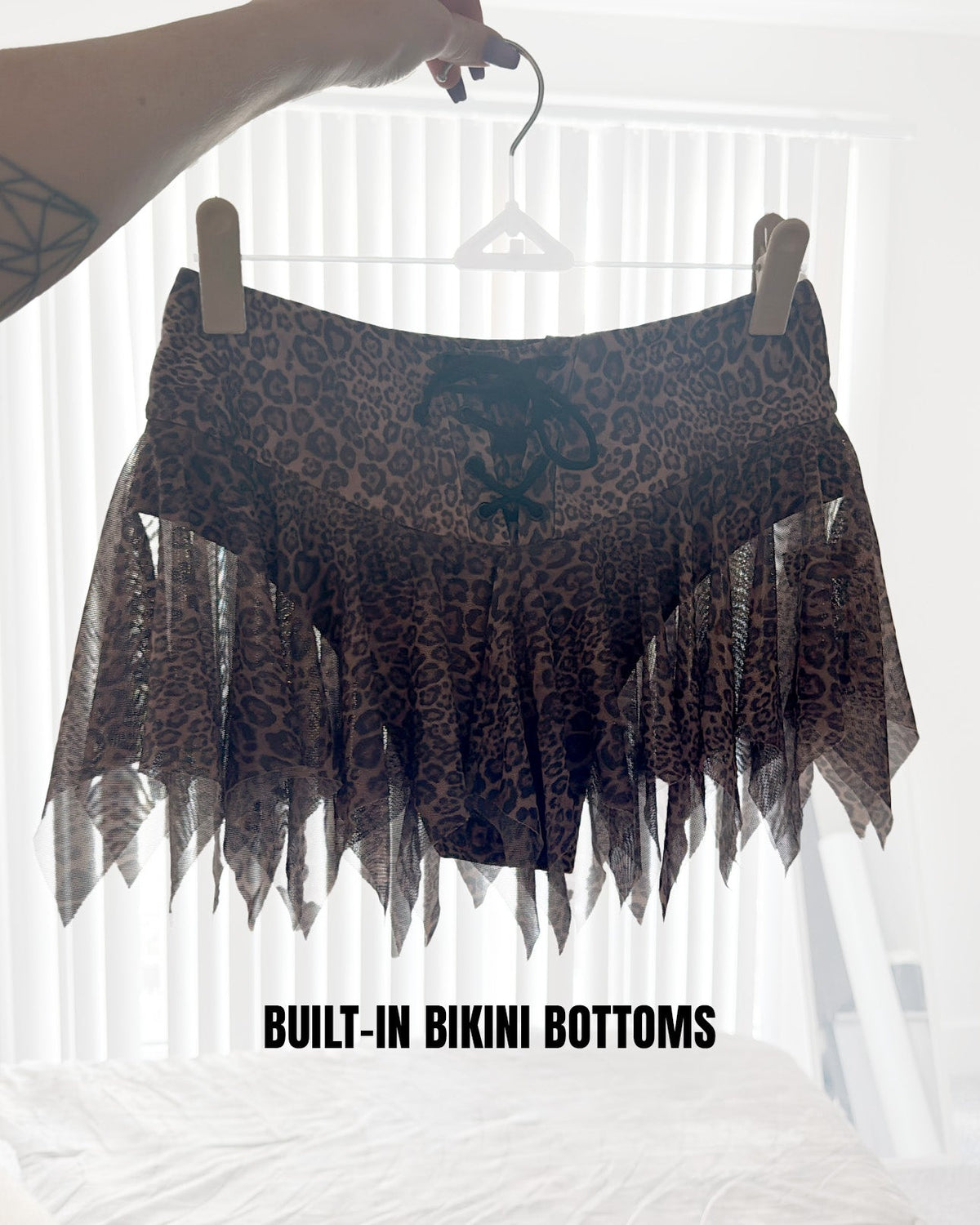 Leopard Luxe Mini Skirt by SUSPEX Rave Outfits featuring a stylish leopard print and edgy rave-inspired design.