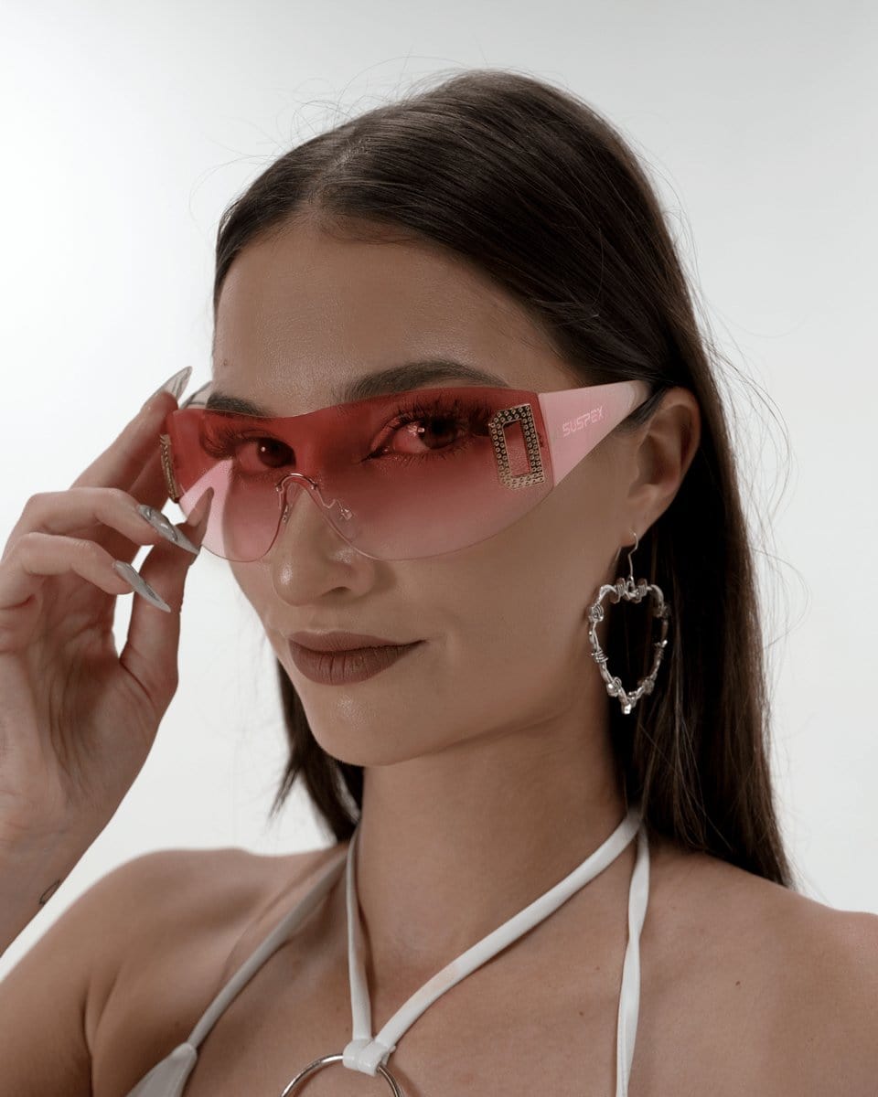 Neon pink shield sunglasses by SUSPEX Rave Outfits with bold, reflective lenses and a futuristic design on a white background.