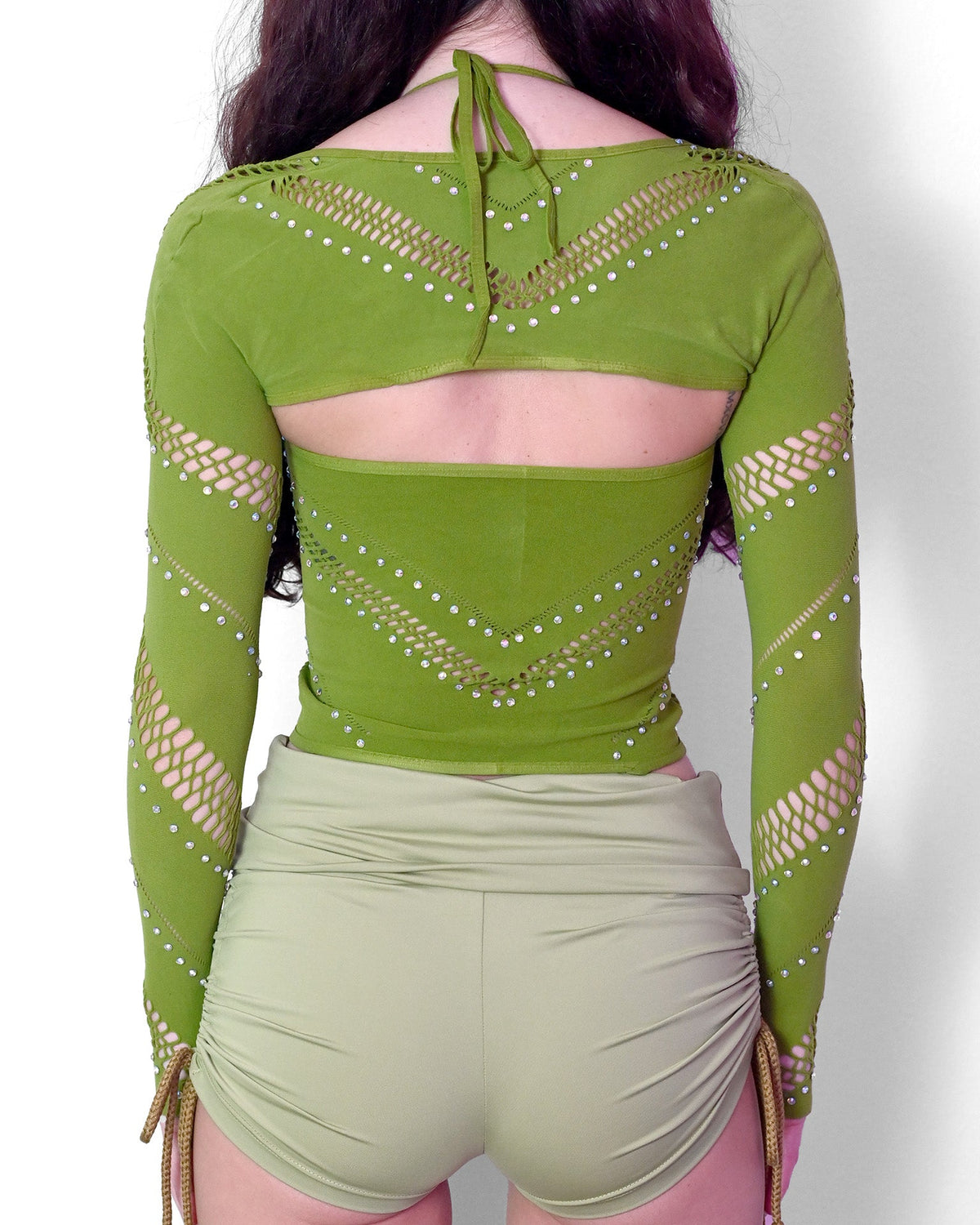 Green halter bolero festival top with cutout design by SUSPEX Rave Outfits, featuring vibrant fabric and stylish fit.