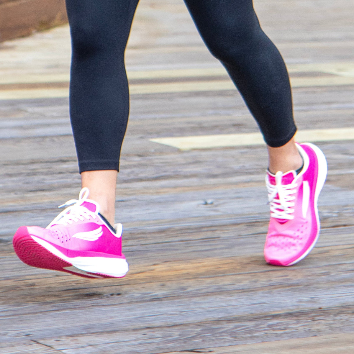 Pink APUS Women athletic shoes by Swift Running, featuring breathable mesh and cushioned sole for comfortable active wear.