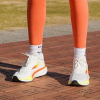 White APUS women’s athletic shoes by Swift Running featuring a sleek design and comfortable fit for active wear.