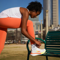 Swift Running APUS Women athletic shoes in white, featuring a sleek design and comfortable fit for active wear.