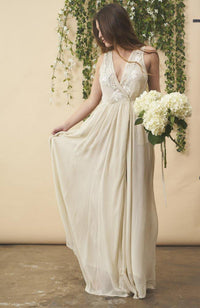 Cream floral embroidered wedding dress by SymbologyClothing featuring silver accents and intricate embroidery on a flowing fabric.