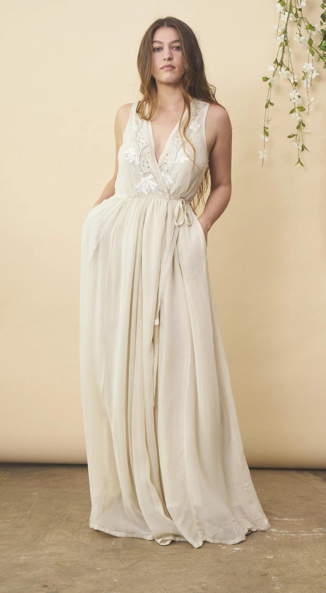 Cream floral embroidered wedding dress with silver details by SymbologyClothing, featuring intricate embroidery and elegant design.