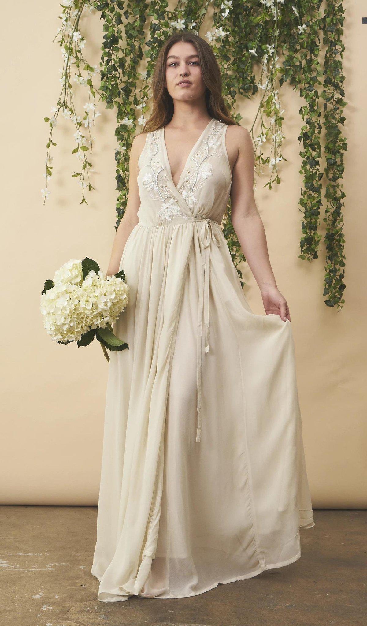 Cream floral embroidered wedding dress with silver accents by SymbologyClothing, featuring intricate embroidery and elegant bridal design.