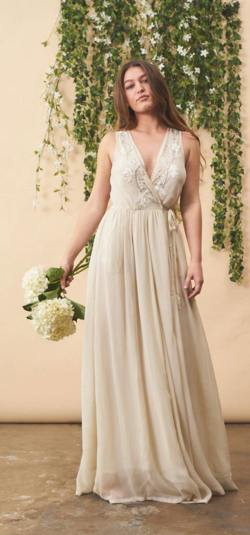 Cream floral embroidered wedding dress with silver accents by SymbologyClothing, featuring intricate embroidery and elegant design.