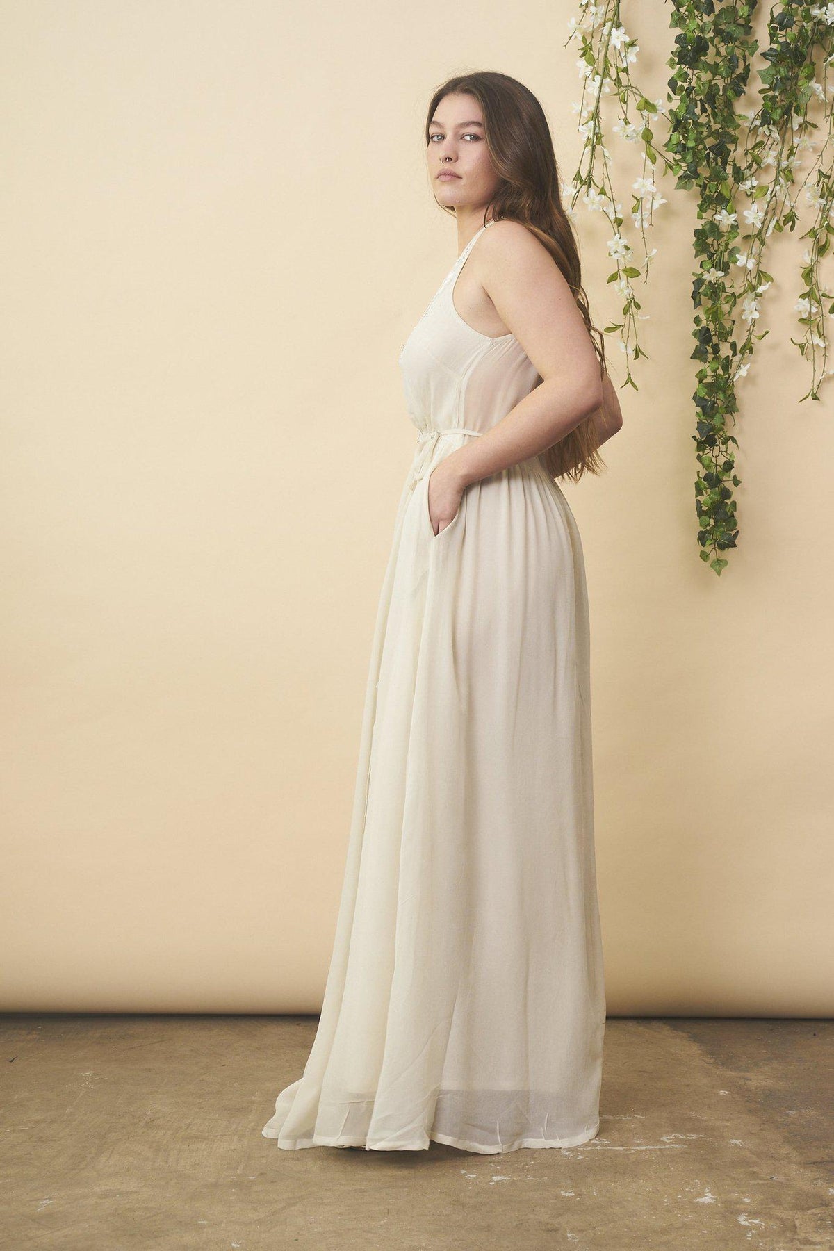 Cream floral embroidered wedding dress with silver accents by SymbologyClothing, featuring intricate embroidery and elegant design.