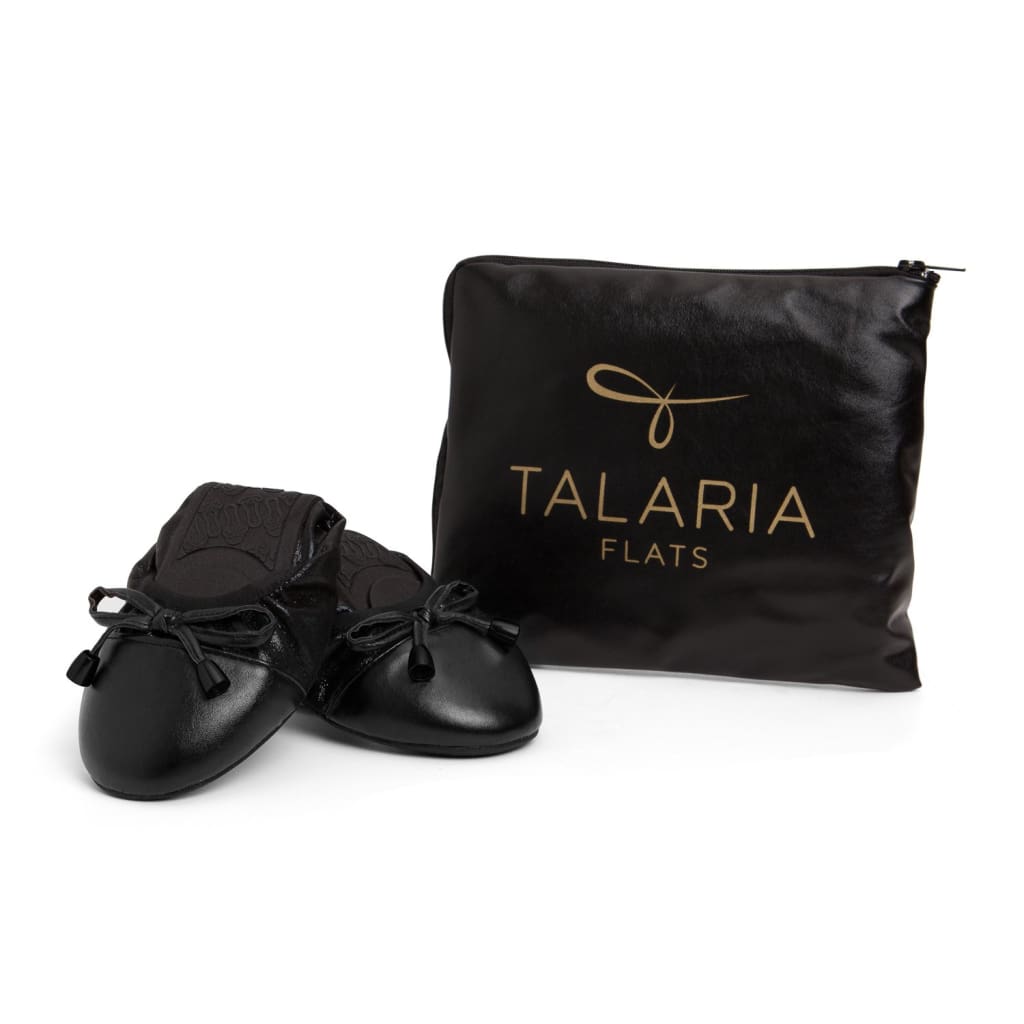 Black Talaria Flats shoes with sleek, smooth design and pointed toes, showcasing a stylish and comfortable footwear option.