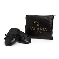 Black Talaria Flats shoes with sleek, smooth design and pointed toes, showcasing a stylish and comfortable footwear option.