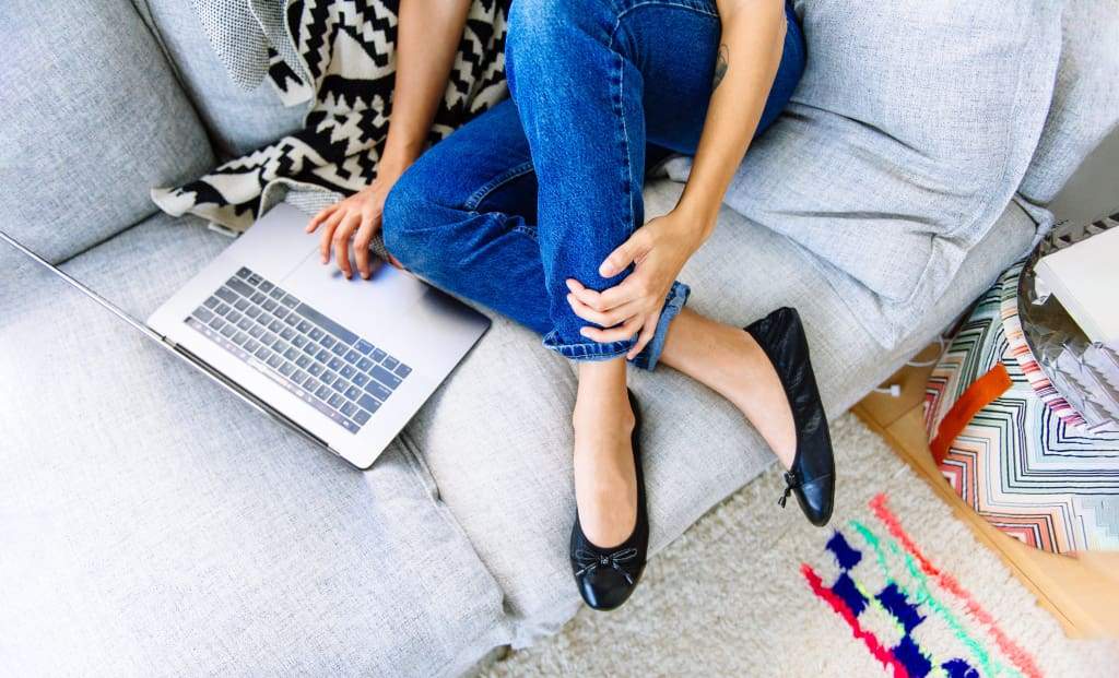 Black Talaria Flats shoes with sleek, premium design, featuring a smooth finish and classic slip-on style.