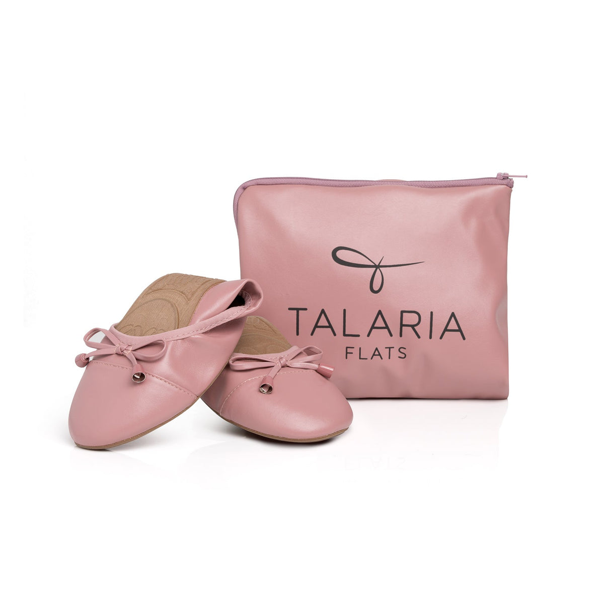 Talaria Flats dusty rose shoes folded in front of a bag, showcasing stylish and comfortable women's flats.
