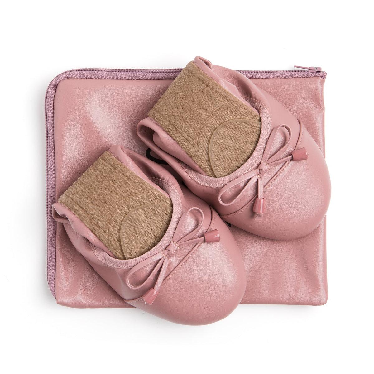 Talaria Flats premium dusty rose shoes folded on a bag, showcasing their soft fabric and stylish design.
