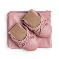 Talaria Flats premium dusty rose shoes folded on a bag, showcasing their soft fabric and stylish design.