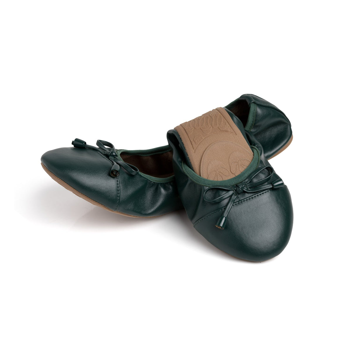 Green Talaria Flats shoes with a half-folded design, showcasing their sleek and stylish evergreen footwear.
