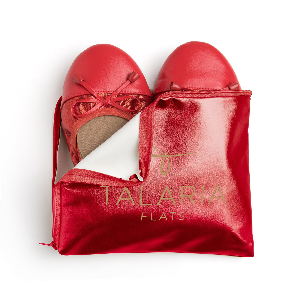 Talaria Flats premium ruby red flats inside a stylish bag, showcasing elegant slip-on shoes with a vibrant red color.