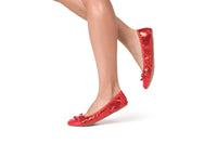 Red Talaria Flats shoes in ruby red with a sleek, comfortable design, perfect for everyday wear.