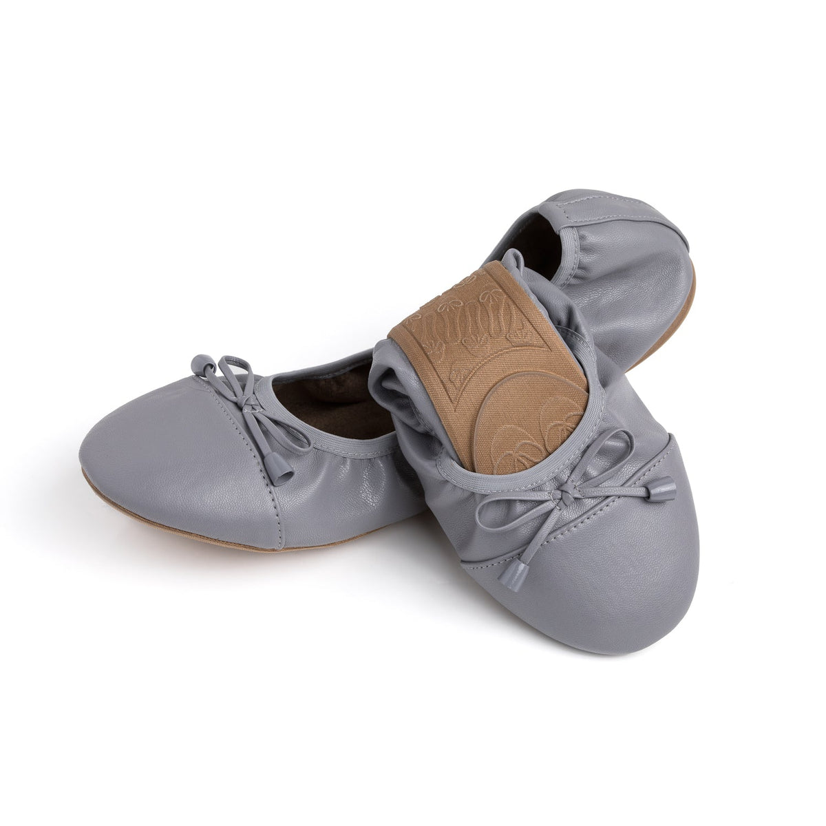 Talaria Flats in stone grey, half-folded shoes showing smooth leather material and elegant design.